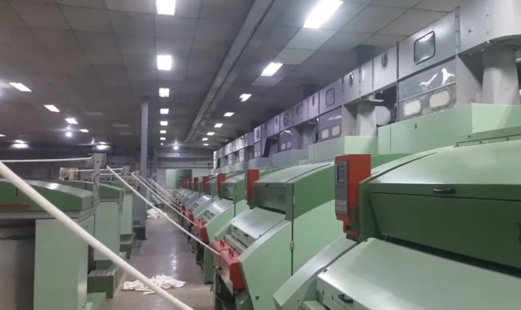 Carding machine producing sliver in a textile spinning factory.